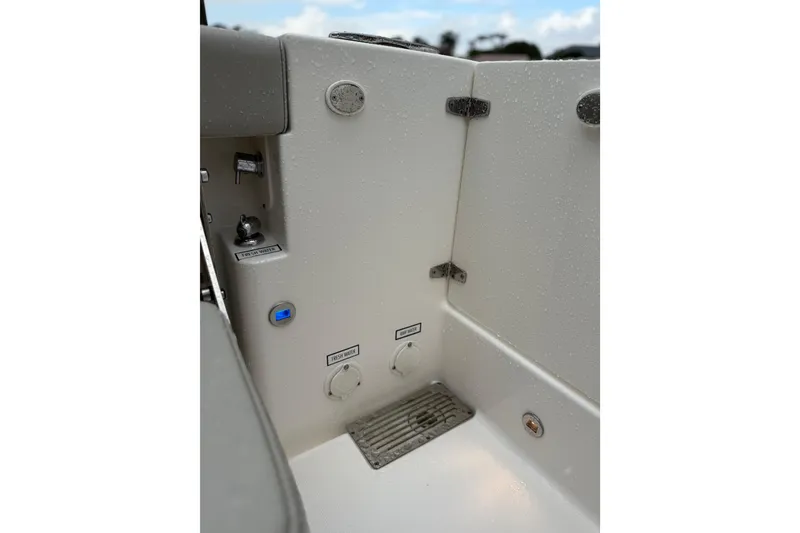 Slide: The Image of 2025 Pursuit OS 325 Offshore boat interior with fresh water controls and drainage system. - 13