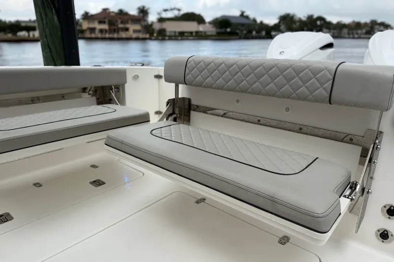Slide: The Image of 2025 Pursuit OS 325 Offshore boat with luxurious gray seating and quilted design. - 14