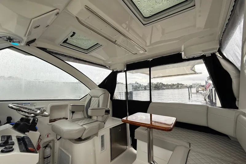 Slide: The Image of Interior of 2025 Pursuit OS 325 Offshore boat with seating and helm, overlooking water. - 35