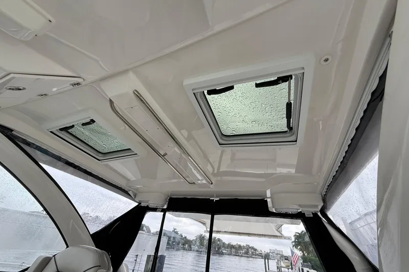 Slide: The Image of Interior view of 2025 Pursuit OS 325 Offshore boat with rain-covered skylights. - 36