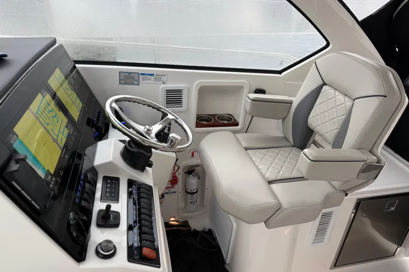 Slide: The Image of 2025 Pursuit OS 325 Offshore helm with modern controls and luxurious seating. - 41