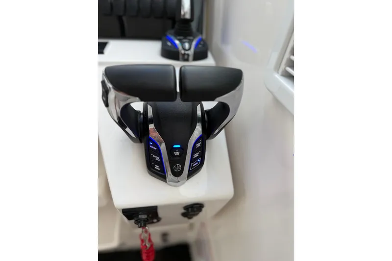 Slide: The Image of Control panel of 2025 Pursuit OS 325 Offshore boat with illuminated buttons. - 46