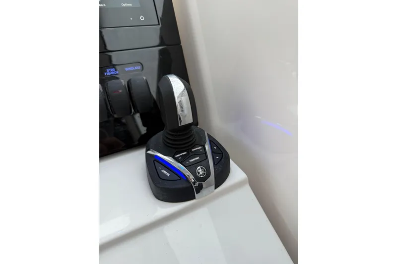 Slide: The Image of Joystick control on 2025 Pursuit OS 325 Offshore boat dashboard. - 47