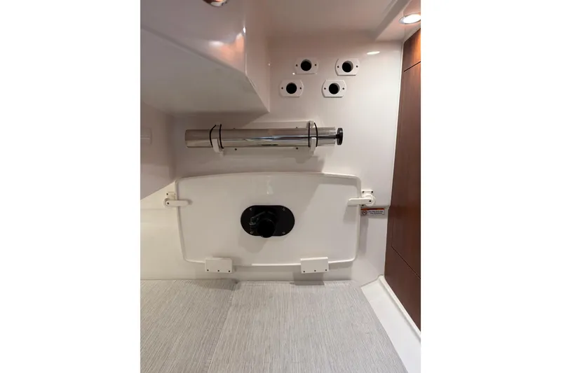 Slide: The Image of Interior view of 2025 Pursuit OS 325 Offshore boat, featuring storage and fixtures. - 61