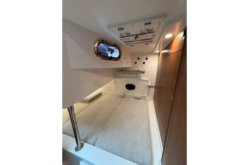 Slide: The Image of 2025 Pursuit OS 325 Offshore cabin interior with modern design and wood accents. - 63