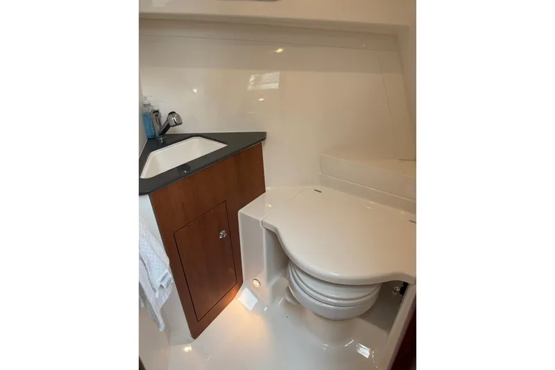 Slide: The Image of 2025 Pursuit OS 325 Offshore boat bathroom with sink and toilet. - 67