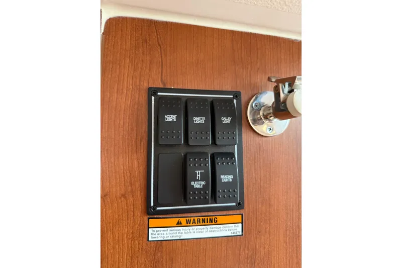 Slide: The Image of Control panel on 2025 Pursuit OS 325 Offshore boat with labeled light switches. - 71