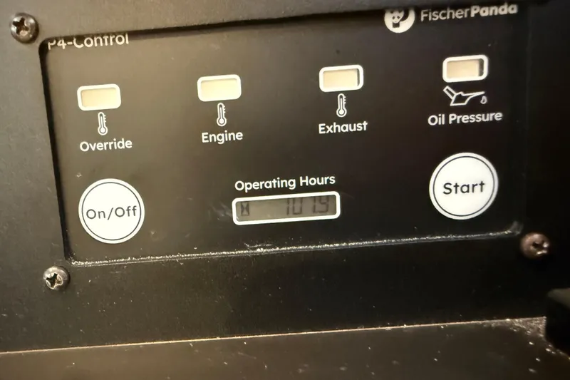Slide: The Image of Control panel of a Fischer Panda generator on a 2025 Pursuit OS 325 Offshore boat. - 73