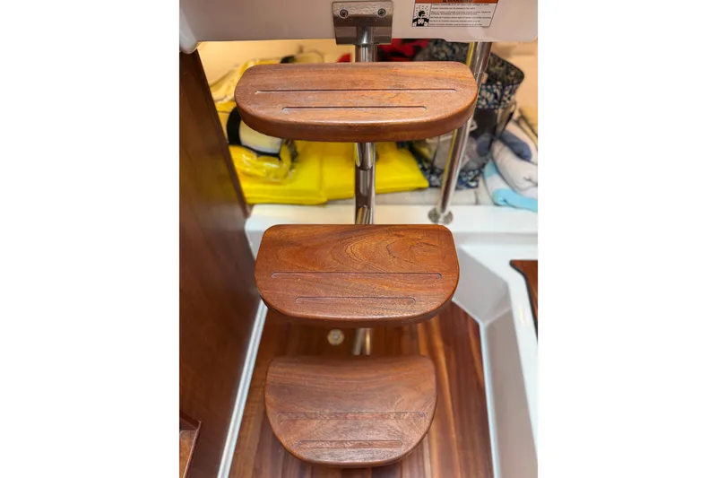 Slide: The Image of Wooden steps on a 2025 Pursuit OS 325 Offshore boat interior. - 74