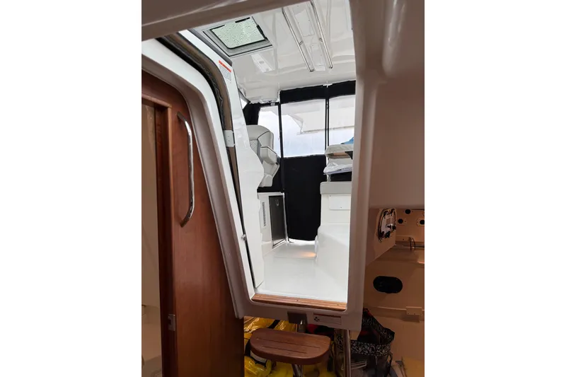 Slide: The Image of Interior view of 2025 Pursuit OS 325 Offshore boat, showcasing cabin and seating area. - 75