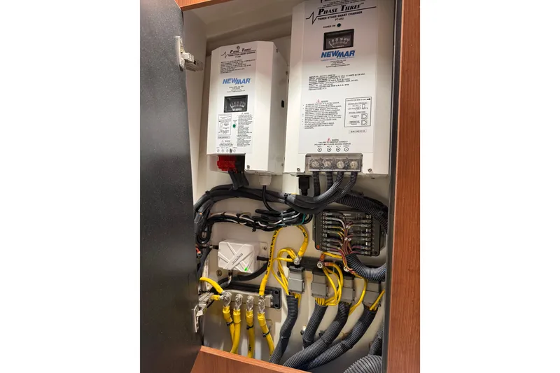 Slide: The Image of Electrical panel inside 2025 Pursuit OS 325 Offshore boat, featuring Newmar components. - 77