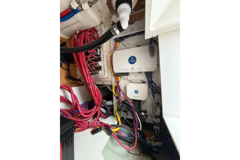 Slide: The Image of Electrical wiring and components inside a 2025 Pursuit OS 325 Offshore boat. - 81