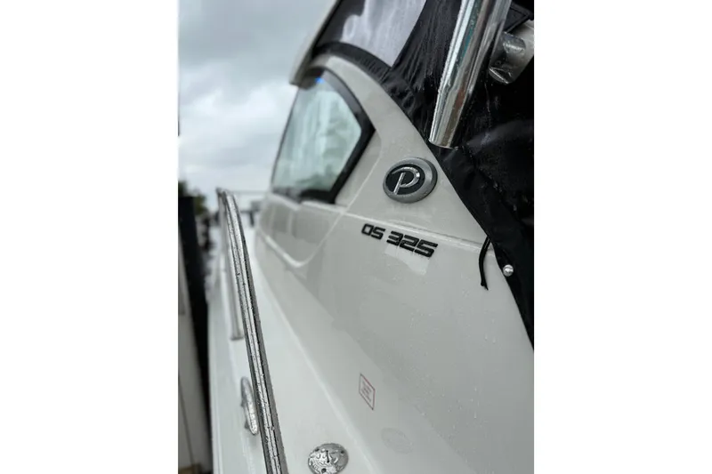 Slide: The Image of 2025 Pursuit OS 325 Offshore boat, close-up of logo and model name. - 85