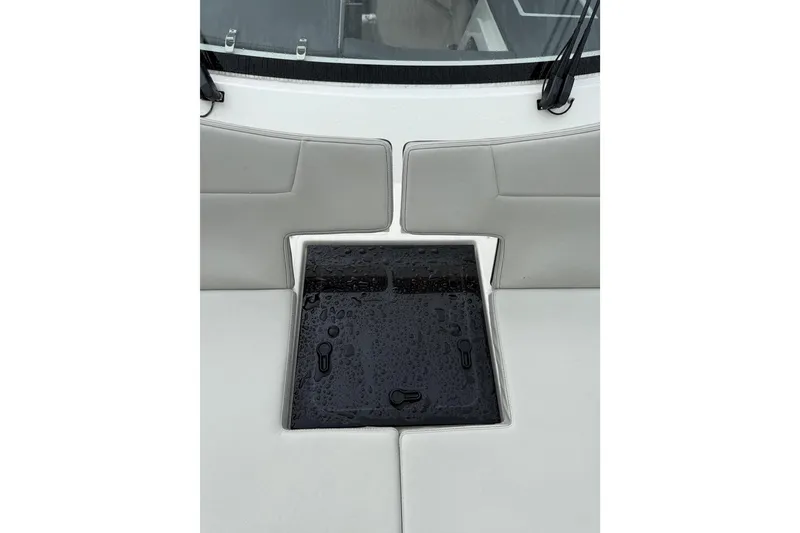 Slide: The Image of 2025 Pursuit OS 325 Offshore boat seating with wet black hatch cover. - 92