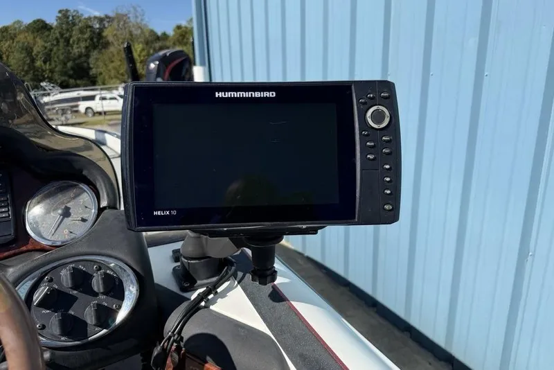 Slide: The Image of Control panel of a 2005 Triton TR-21 boat with various switches and dials. - 13