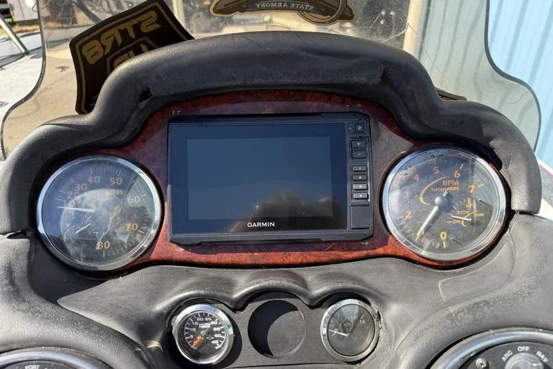 Slide: The Image of Steering wheel of a 2005 Triton TR-21 boat with dashboard instruments. - 17