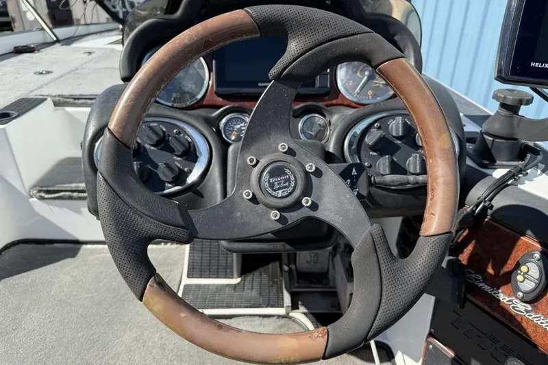 Slide: The Image of 2005 Triton TR-21 Limited Edition boat dashboard with controls and key ignition. - 18