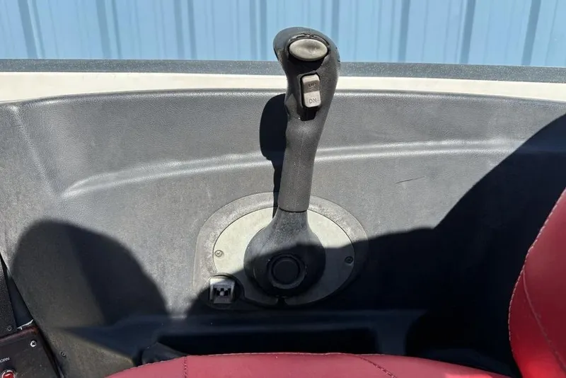 Slide: The Image of 2005 Triton TR-21 boat interior with red and gray seating, cup holders, and warning label. - 20