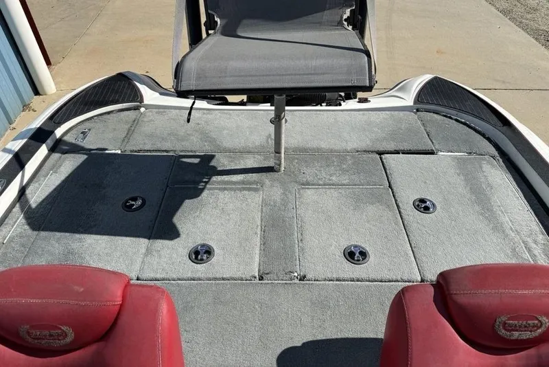 Slide: The Image of 2005 Triton TR-21 boat interior with red seats and steering console. - 23