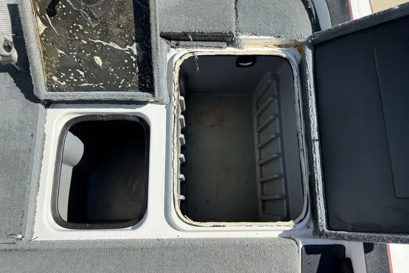 Slide: The Image of 2005 Triton TR-21 boat storage compartments with propeller and wiring. - 26