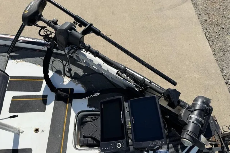 Slide: The Image of 2005 Triton TR-21 boat deck with gray carpeting and storage compartments. - 4