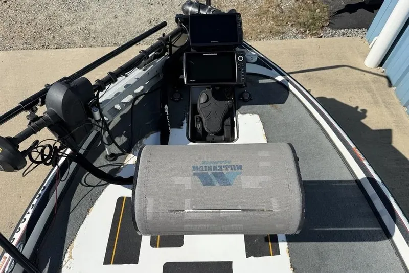 Slide: The Image of 2005 Triton TR-21 boat deck with Bass Pro Shops logo and carpeted surface. - 7