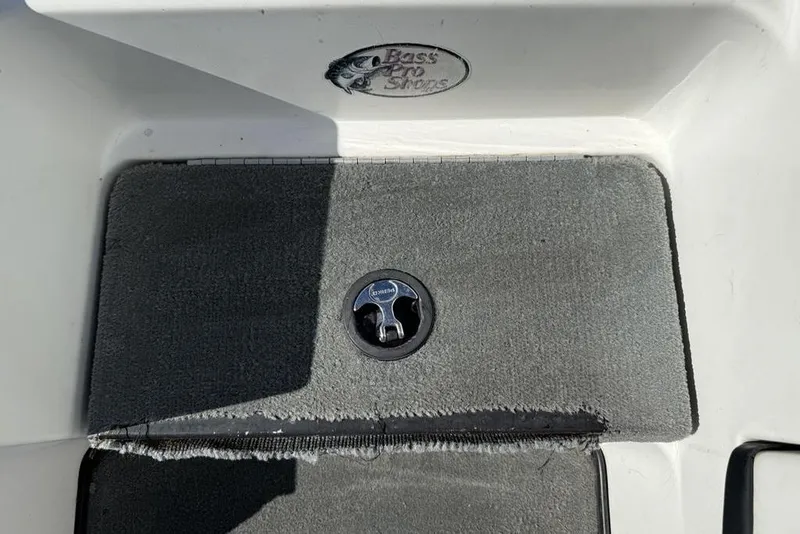 Slide: The Image of Open storage compartment on a 2005 Triton TR-21 boat, showing interior details. - 8