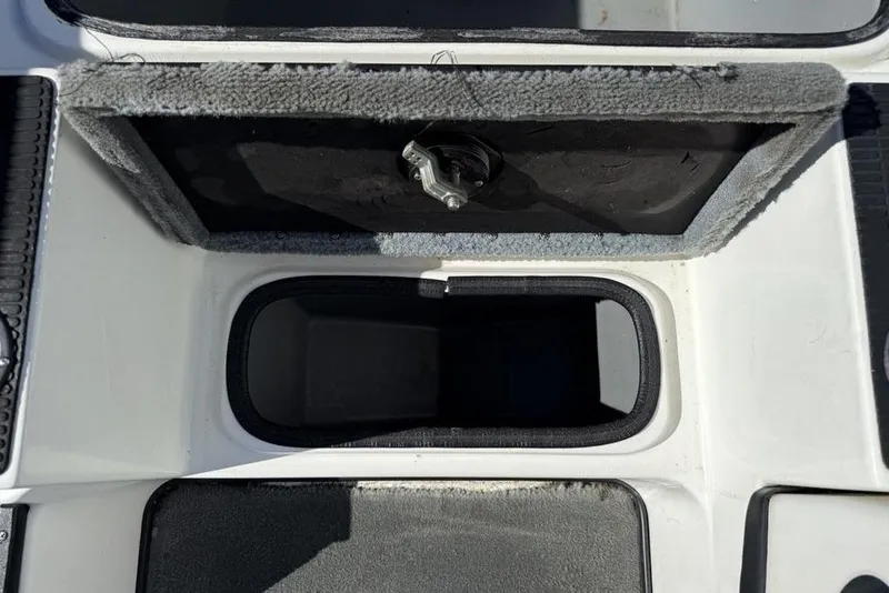 Slide: The Image of Open storage compartment on a 2005 Triton TR-21 boat, showing interior details. - 9