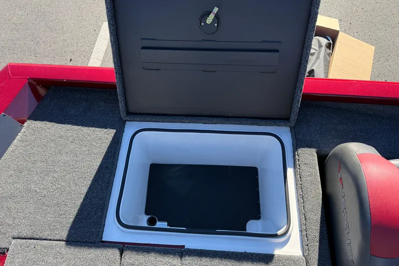 Slide: The Image of Open storage compartment in 2026 Vexus AVX1980 boat, featuring carpeted interior and red accents. - 13