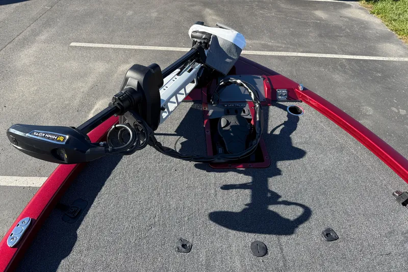 Slide: The Image of 2026 Vexus AVX1980 boat deck with Minn Kota trolling motor, parked on asphalt. - 6