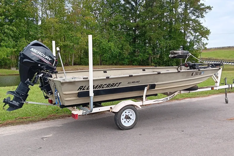 Slide: The Image of 2006 Alumacraft Crappie Jon boat on trailer with Mercury outboard motor. - 1