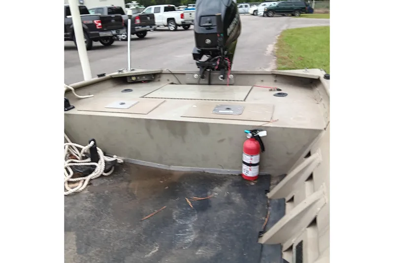 Slide: The Image of 2006 Alumacraft Crappie Jon boat interior with motor and fire extinguisher. - 13