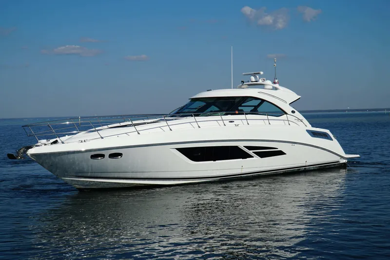 The Image of 2014 Sea Ray 540 Sundancer yacht cruising on calm waters under a clear blue sky. - 0