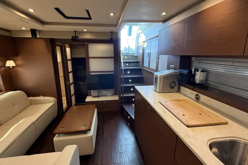 Slide: The Image of Luxurious interior of 2014 Sea Ray 540 Sundancer yacht with modern kitchen and seating area. - 11