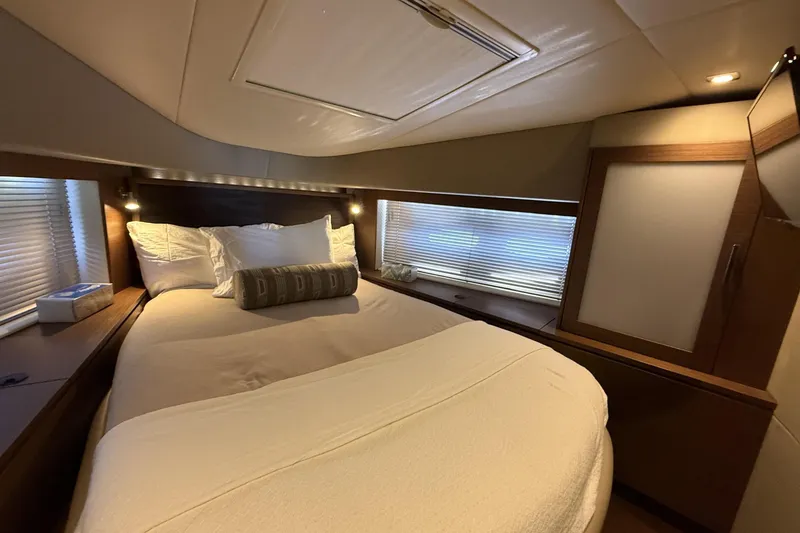 Slide: The Image of Luxurious bedroom interior of 2014 Sea Ray 540 Sundancer yacht with cozy bedding. - 19