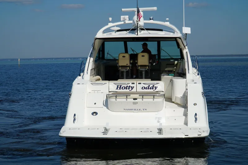 Slide: The Image of 2014 Sea Ray 540 Sundancer yacht on open water, rear view, clear sky. - 3