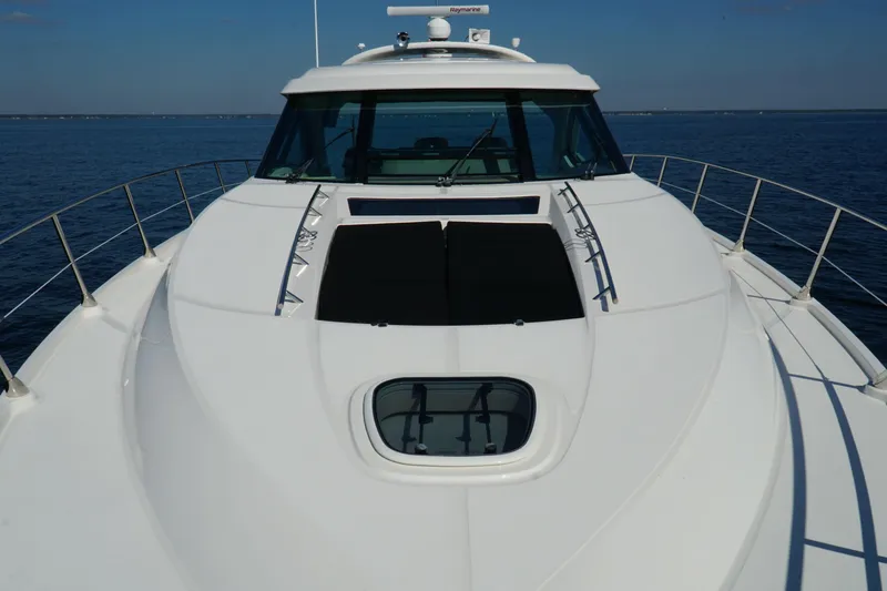 Slide: The Image of 2014 Sea Ray 540 Sundancer yacht on calm blue water, showcasing sleek design and spacious deck. - 4