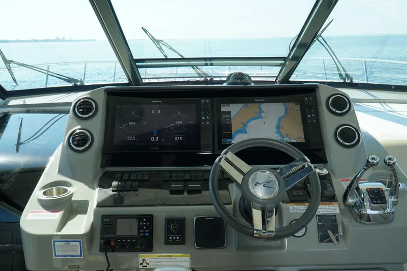 Slide: The Image of Cockpit of 2014 Sea Ray 540 Sundancer with navigation screens and steering wheel. - 7