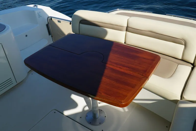 Slide: The Image of Luxury seating area on 2014 Sea Ray 540 Sundancer yacht with wooden table. - 8