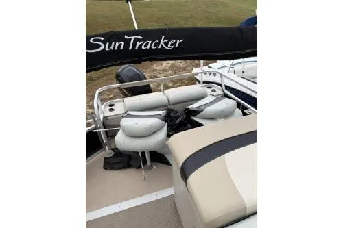 Slide: The Image of 2012 SUNTRACKER FISHING BARGE 22 with cushioned seating and canopy. - 3
