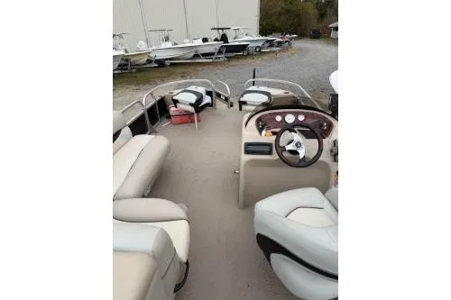 Slide: The Image of 2012 SUNTRACKER FISHING BARGE 22 interior with seating and steering wheel. - 4