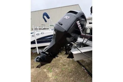 Slide: The Image of 2012 SUNTRACKER FISHING BARGE 22 with Mercury 90 outboard motor, parked on grass. - 5