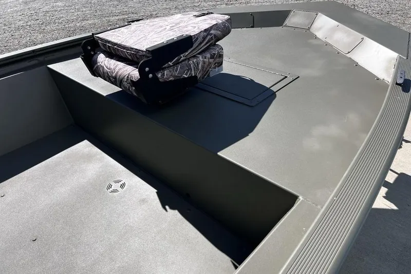 Slide: The Image of 2025 Tracker Grizzly 1648 Utility boat interior with camo seat, gray flooring. - 7