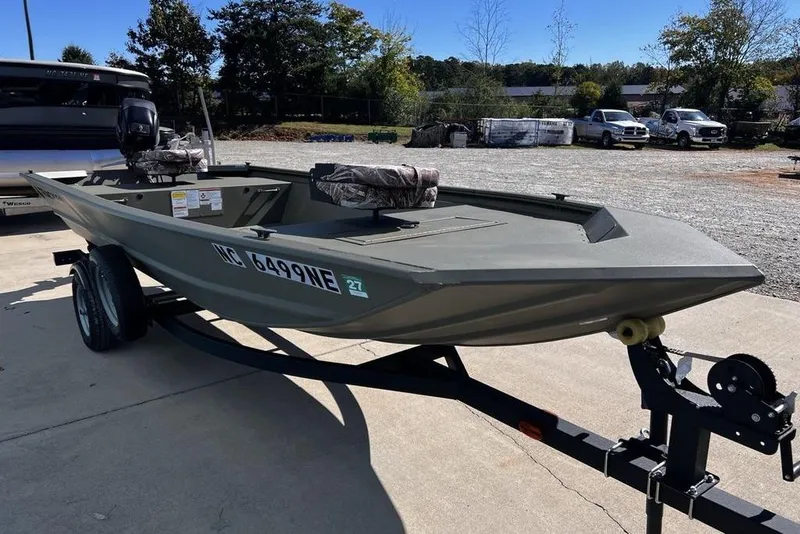 Slide: The Image of 2025 Tracker Grizzly 1648 Utility boat on trailer, parked outdoors. - 9