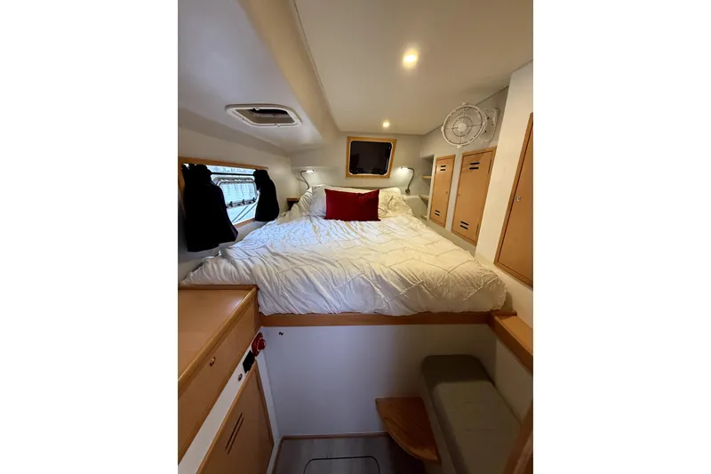 Slide: The Image of Cozy cabin interior of 2021 Celtic Yachts 40, featuring a comfortable bed and wooden storage. - 12