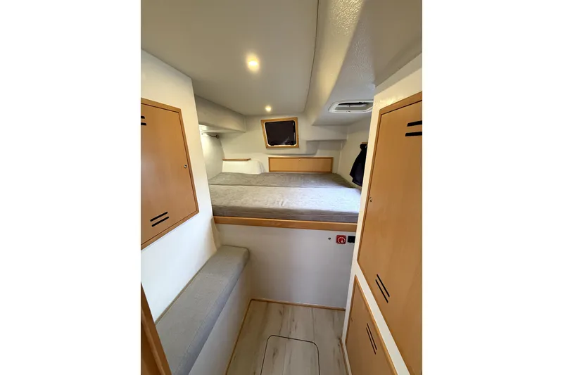 Slide: The Image of Interior cabin of 2021 Celtic Yachts 40, featuring cozy bed and wooden storage. - 13