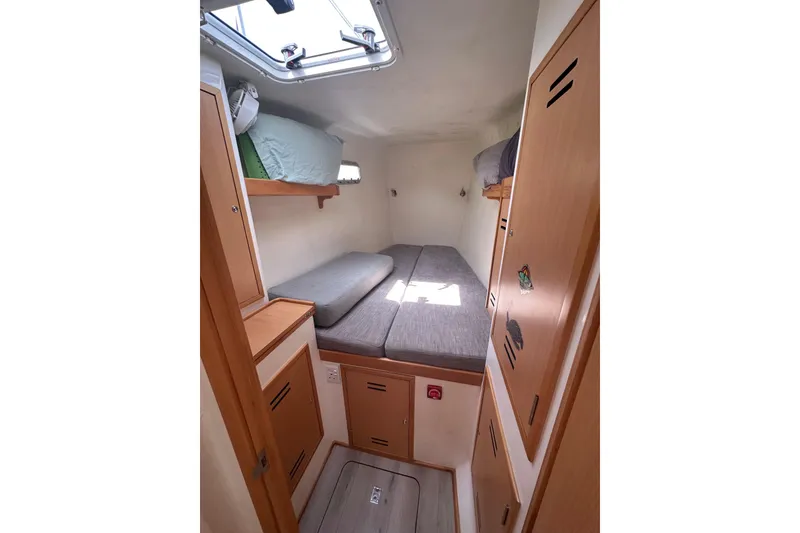 Slide: The Image of Cozy cabin interior of 2021 Celtic Yachts 40, featuring bunk beds and wooden storage. - 14