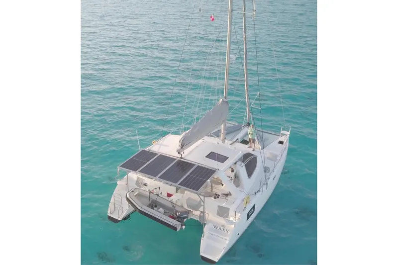 Slide: The Image of 2021 Celtic Yachts 40 catamaran with solar panels on turquoise water. - 2