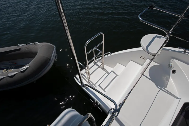 Slide: The Image of Celtic Yachts 40, 2021 model, with steps leading to water and inflatable boat nearby. - 38