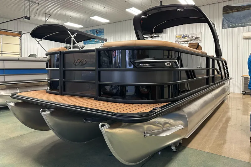 Slide: The Image of 2025 Bentley Pontoons Elite 253 Admiral in showroom, showcasing sleek design and luxury features. - 10